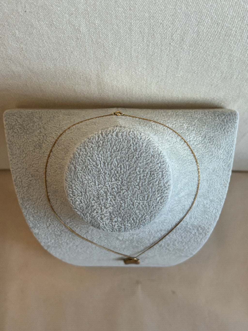 Necklace with a textured surface on a beige background