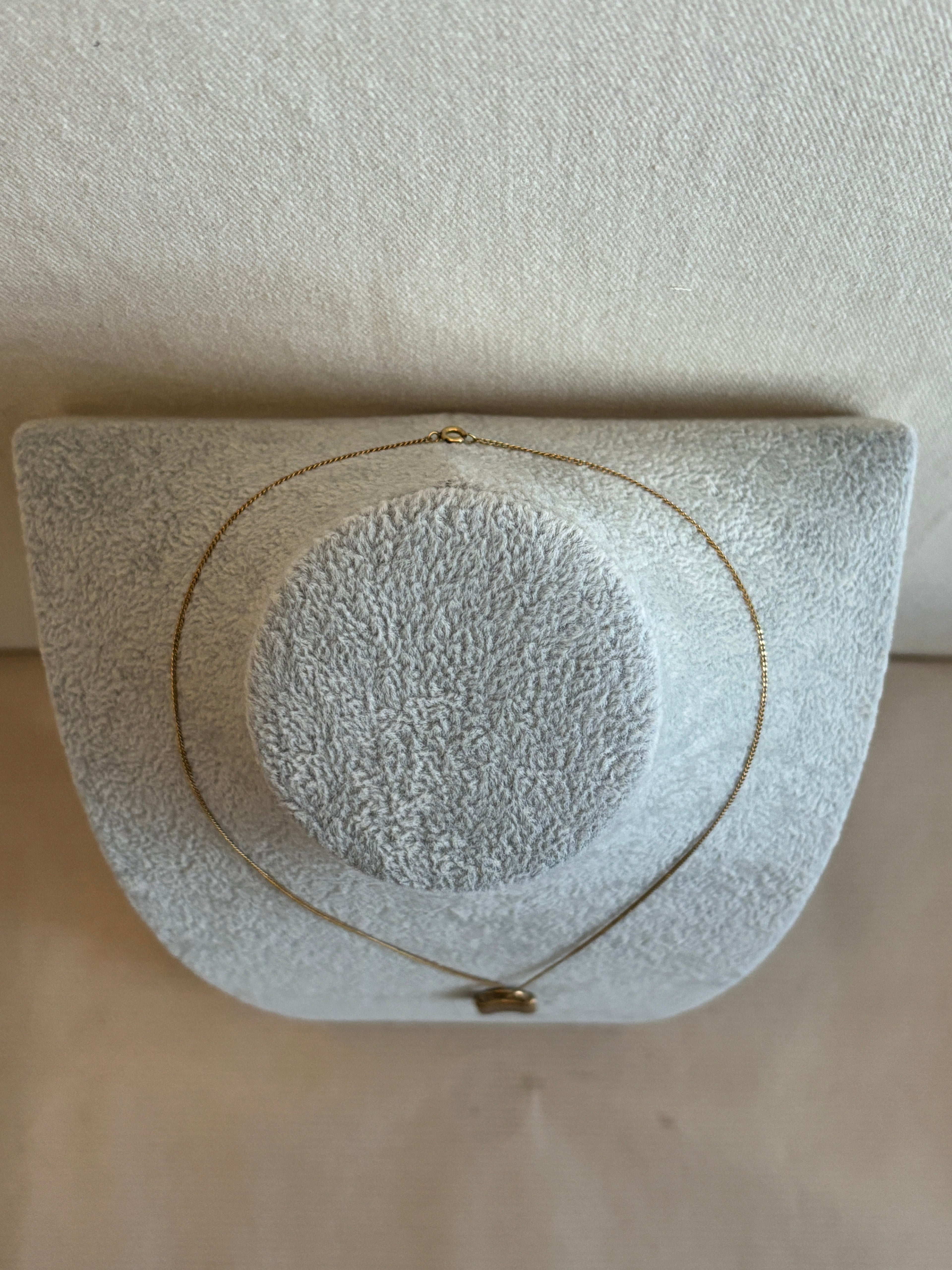 Necklace with a textured surface on a beige background