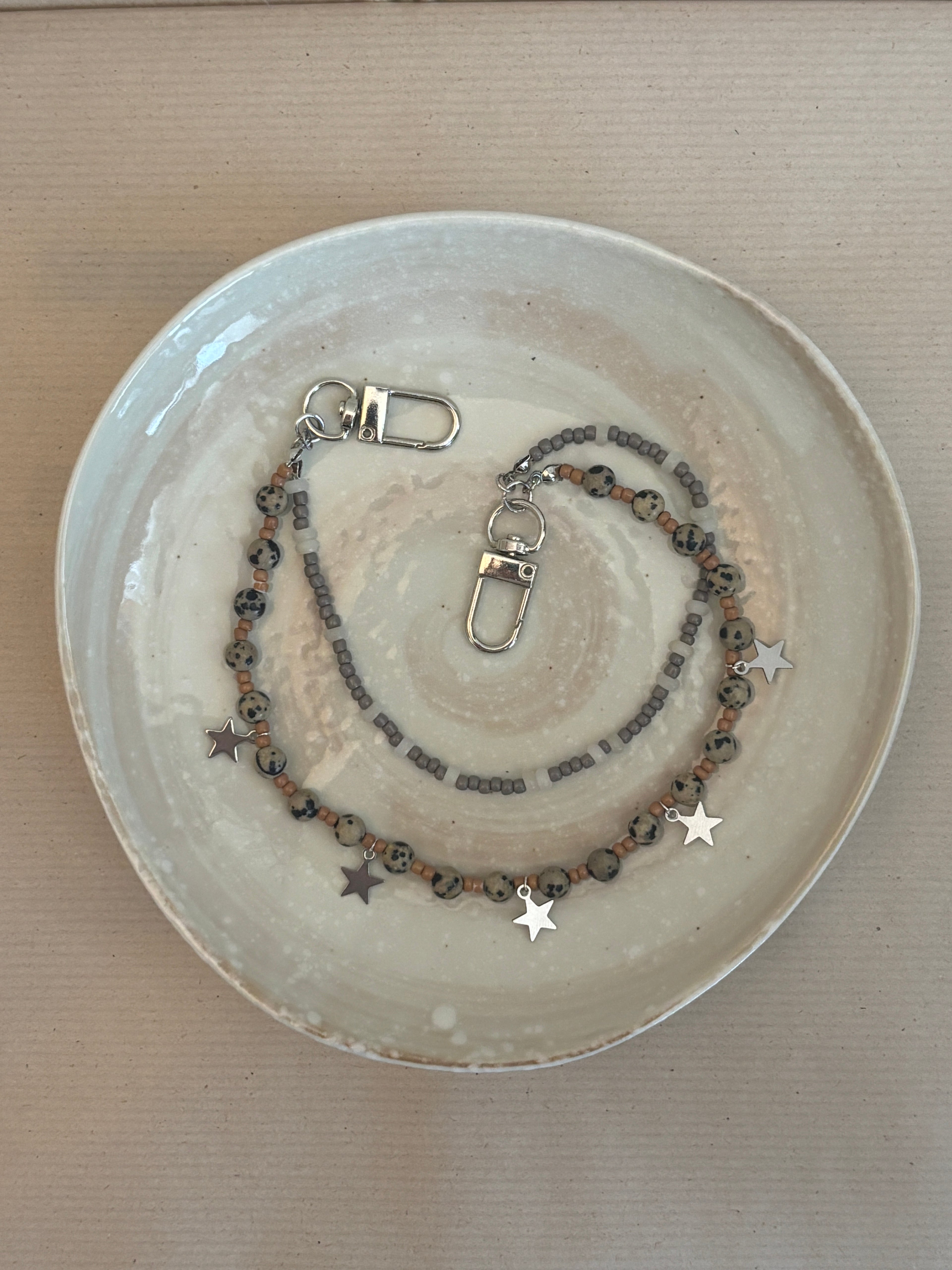 Necklace with star charms on a ceramic plate