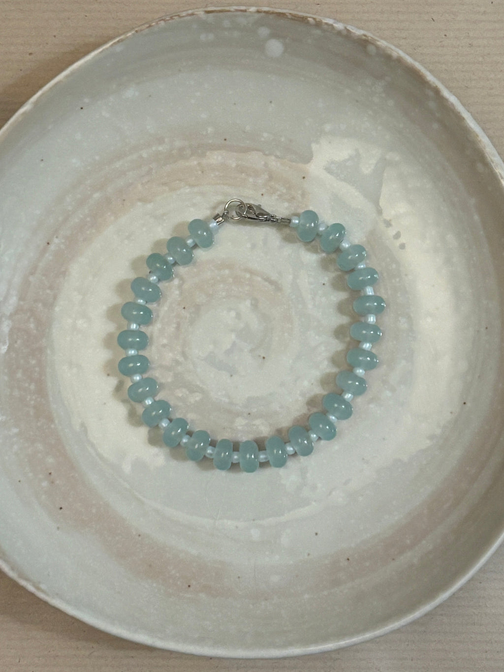 Beaded bracelet on a textured ceramic plate