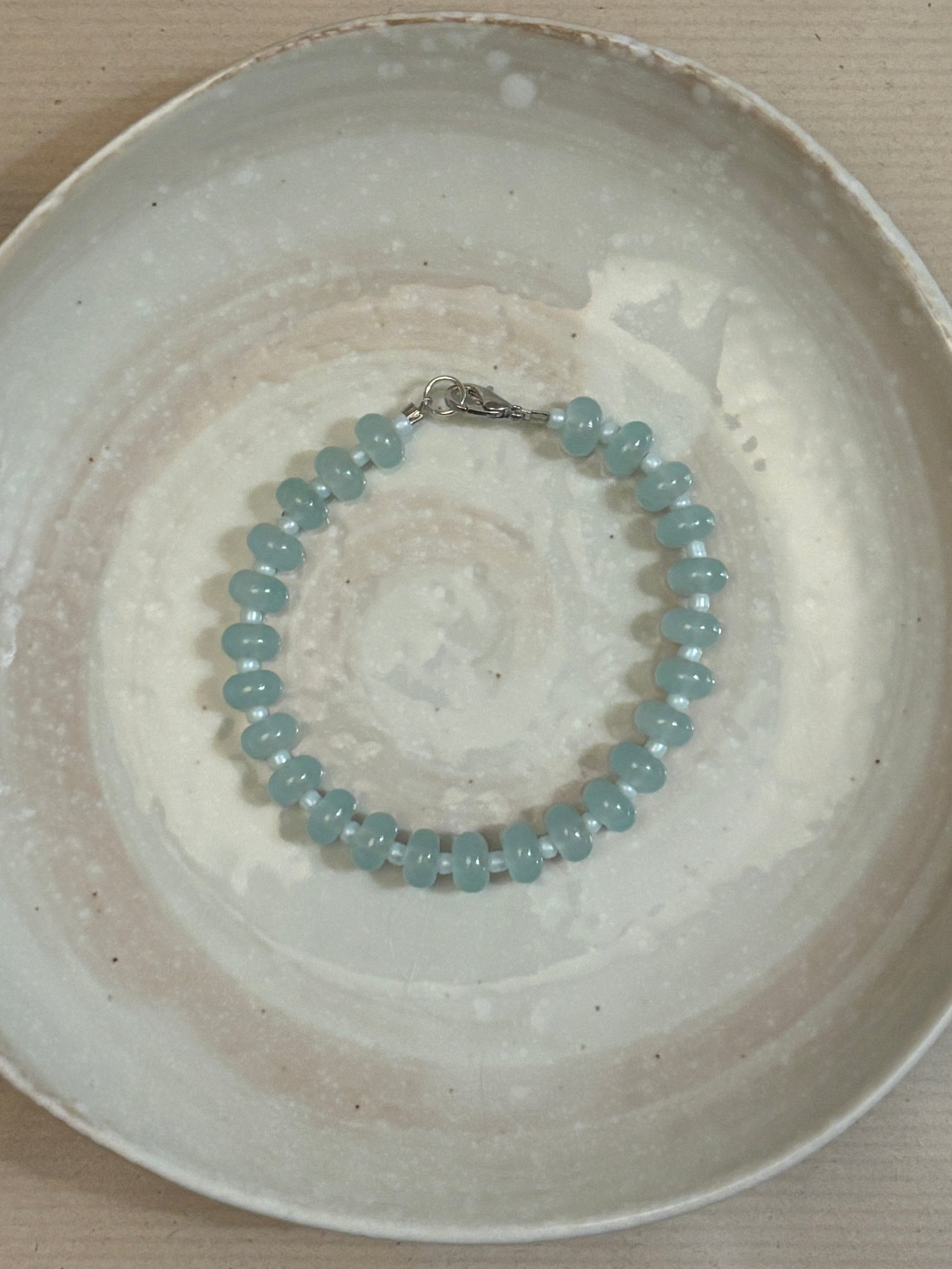Beaded bracelet on a textured ceramic plate