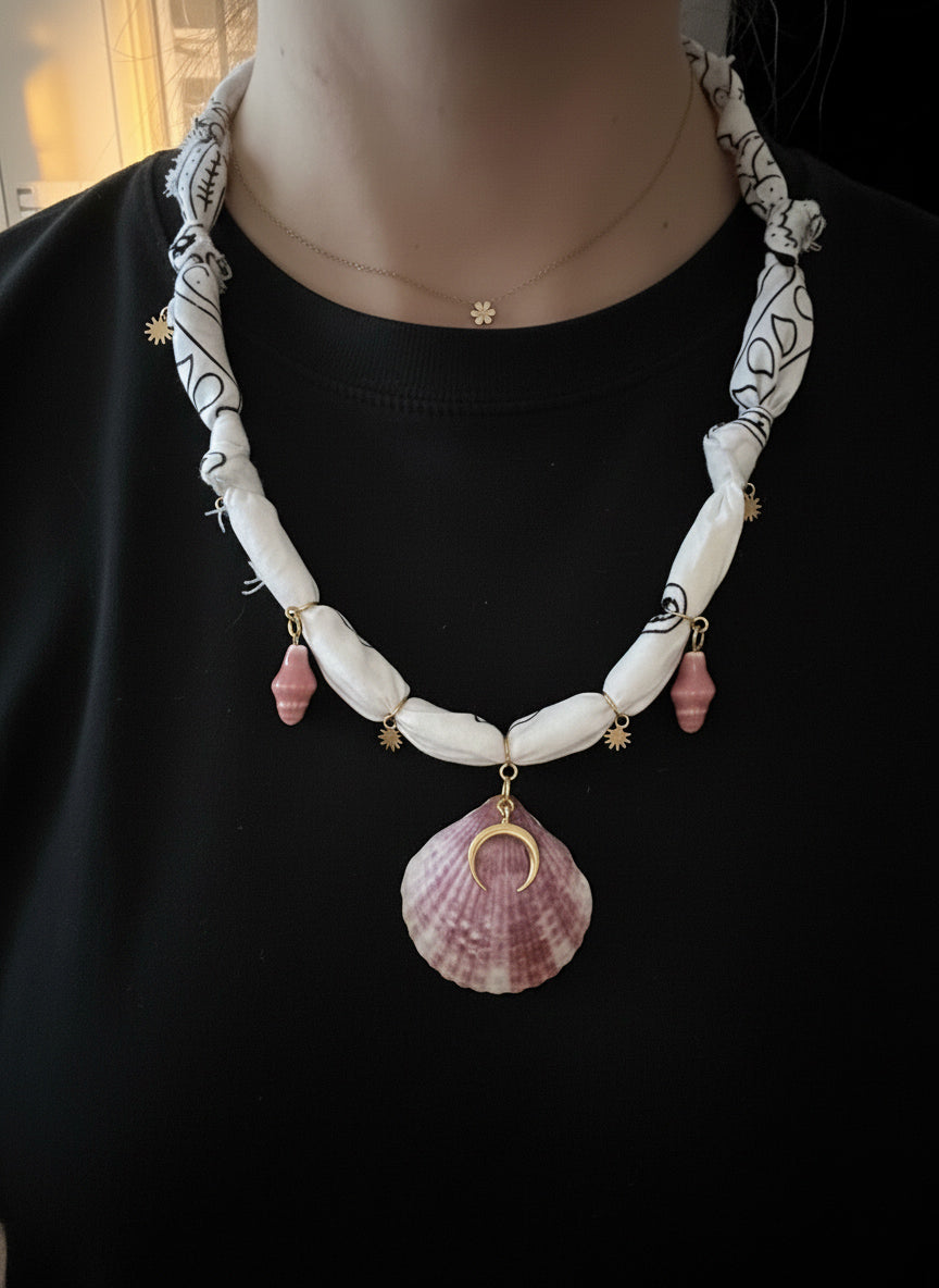 Necklace with shell pendant on a black background