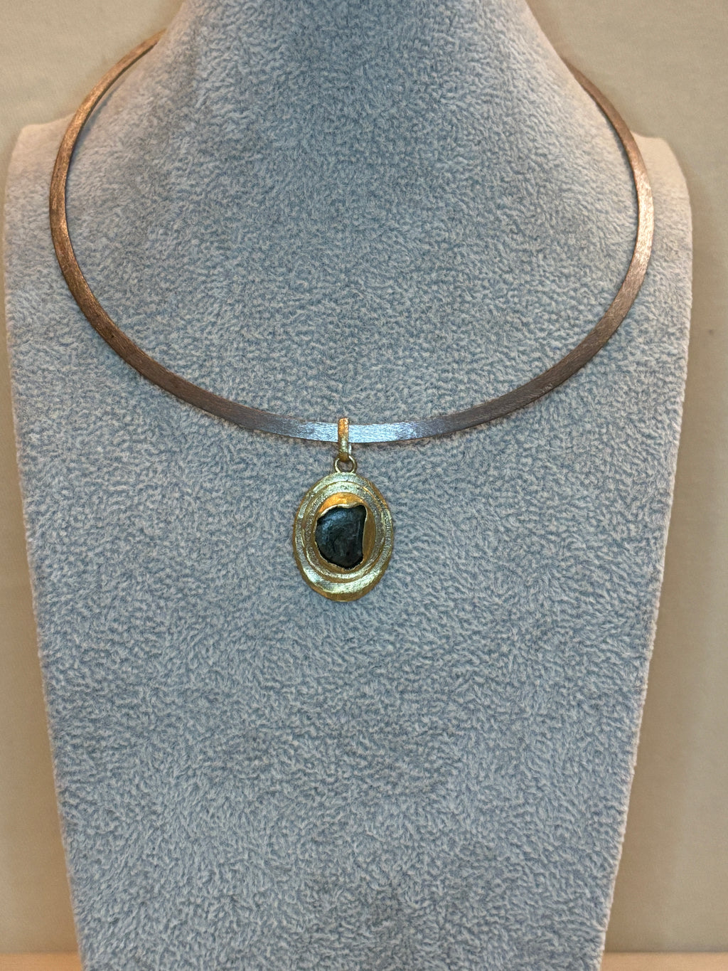 Necklace with a pendant on a textured surface