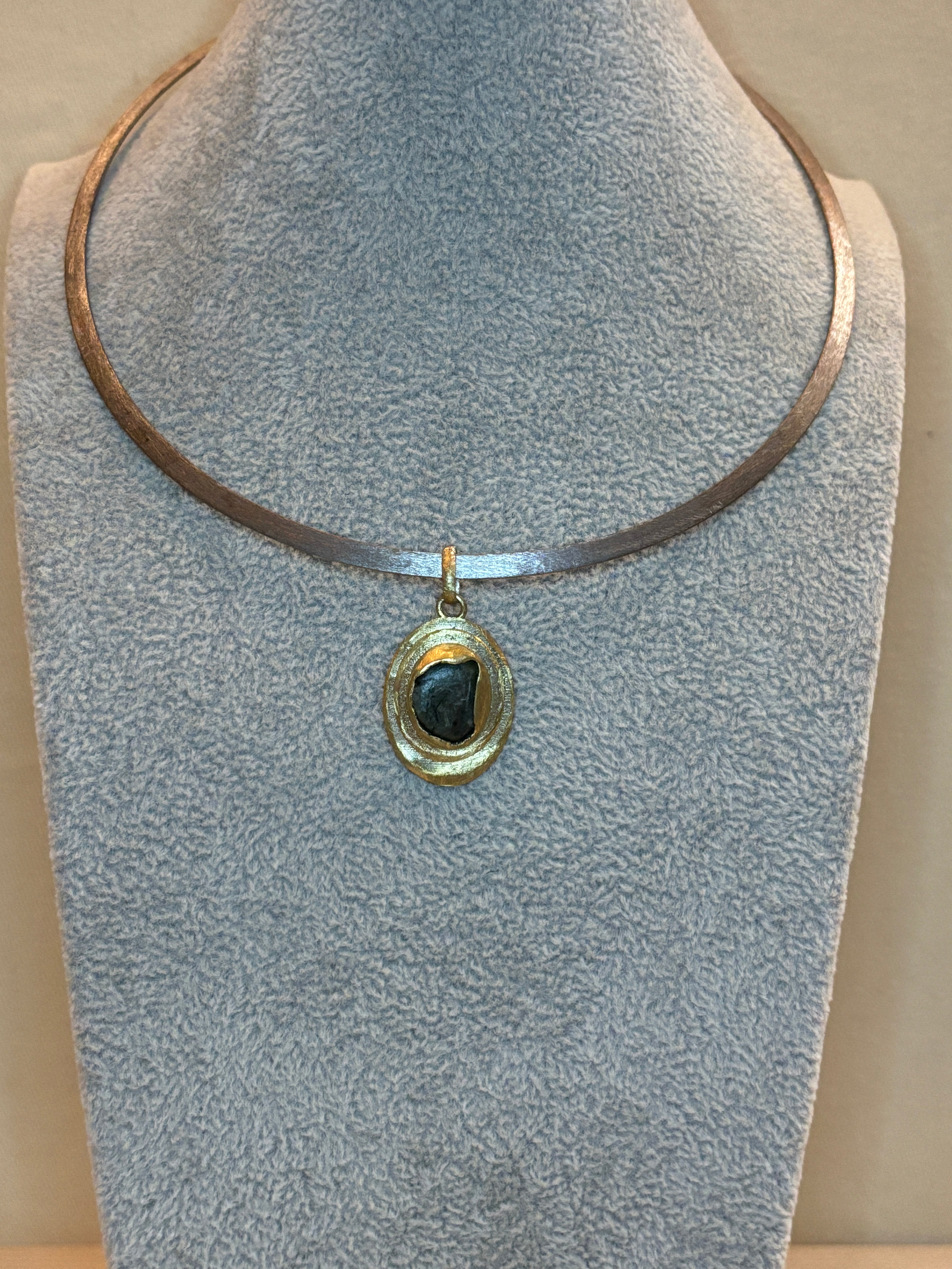 Necklace with a pendant on a textured surface